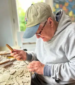Gary using his tools to carve