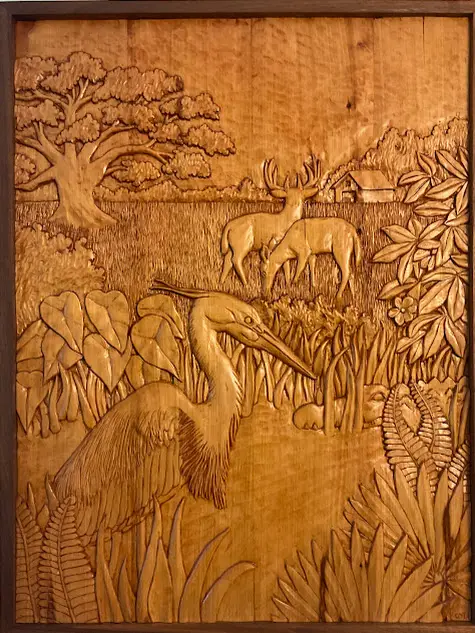Behind the Barn, an award-winning wildlife wood relief carving by Cape Cod artist Gary Cota depicting a heron and alligator in a marsh