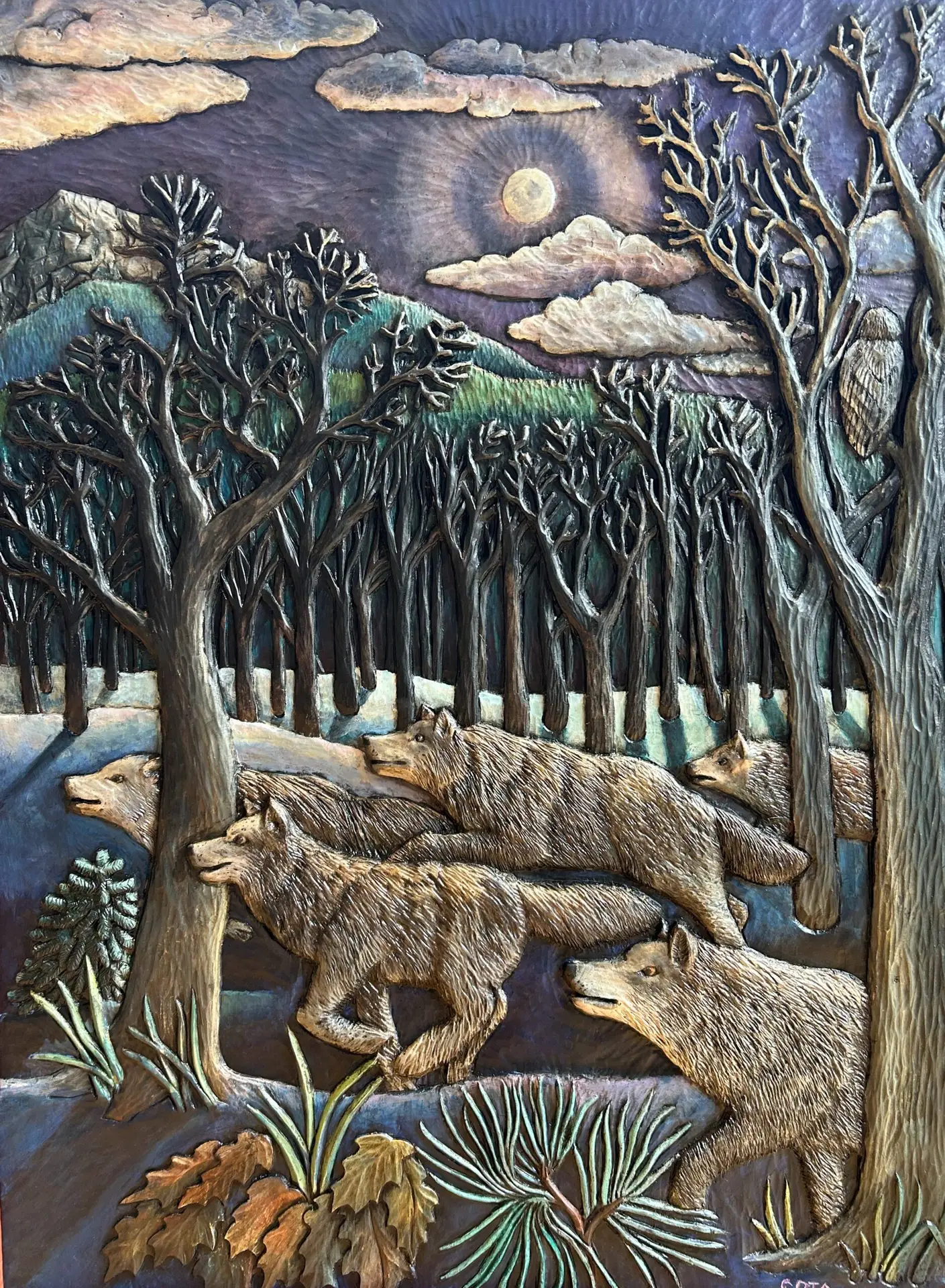 Award-winning wood carving by Gary Cota depicting a pack of wolves moving silently through a moonlit winter forest. Bare trees frame the scene, while a full moon, distant mountains, drifting clouds, and a watchful owl create a dramatic atmosphere that captures the beauty and mystery of the wild.