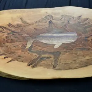 Spalted maple charcuterie board with an inlaid whale design.