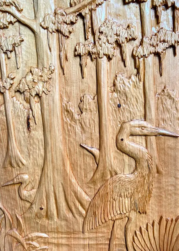 Gary Cota's hand-carved, wood relief of a serene swamp scene with heron slowly moving through