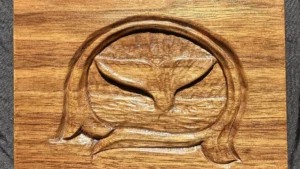 Hand-carved wooden box featuring a whale tail design.