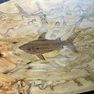 Spalted maple charcuterie board with a hand-carved and inlaid shark.