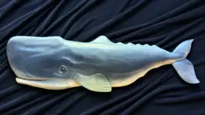 Hand-carved blue-gray whale sculpture designed for outdoor display.