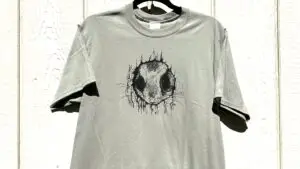 Tan cotton-blend T-shirt featuring an original Gary Cota pen and ink squirrel drawing. Image Caption